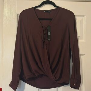 Krisa style brownish long sleeved blouse. Mock cross over with tie at neck line